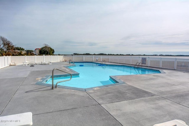 pool featuring fence and a patio