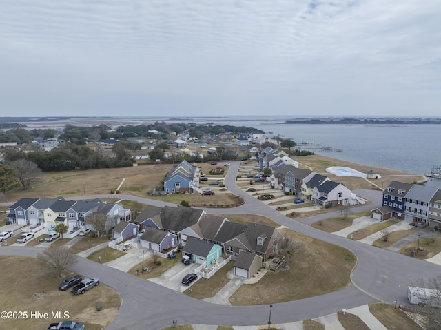 birds eye view of property with a water view and a residential view