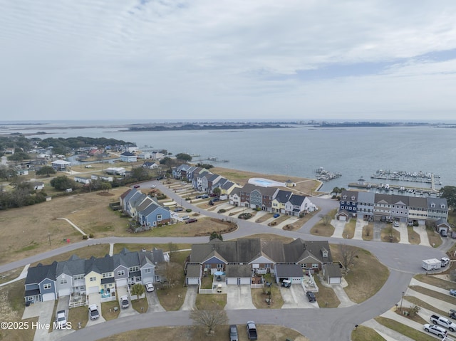 drone / aerial view with a water view and a residential view