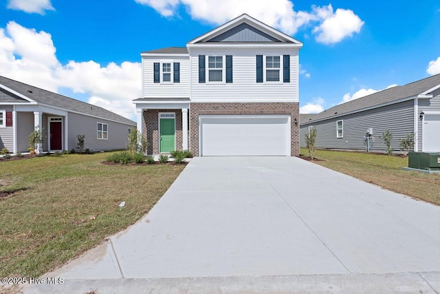 view of front of house featuring an attached garage, concrete driveway, brick siding, and a front yard