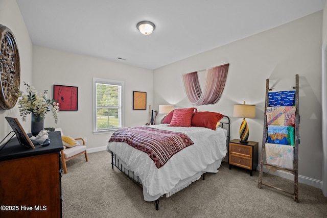 carpeted bedroom featuring visible vents and baseboards