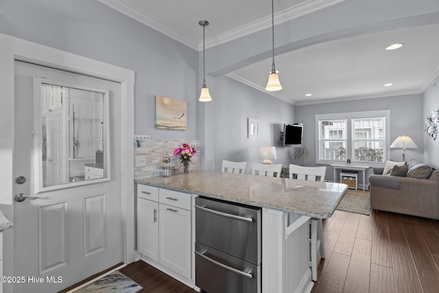 kitchen featuring dark wood finished floors, a peninsula, ornamental molding, white cabinets, and tasteful backsplash