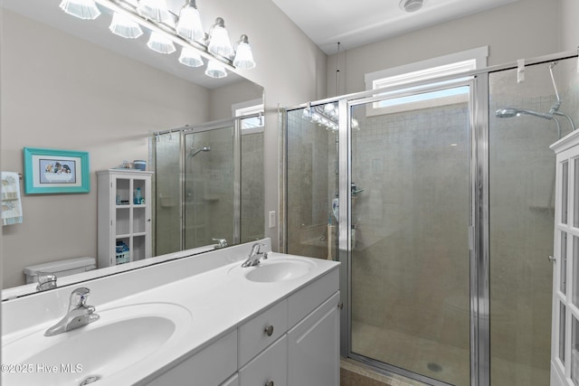 full bathroom with a shower stall, plenty of natural light, and a sink