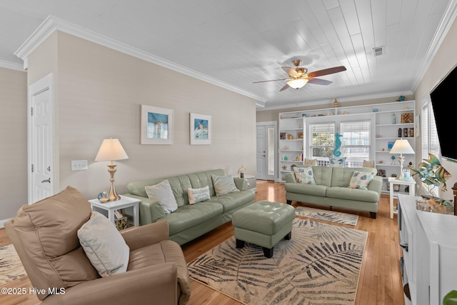 living room with light wood-type flooring, visible vents, a ceiling fan, and crown molding