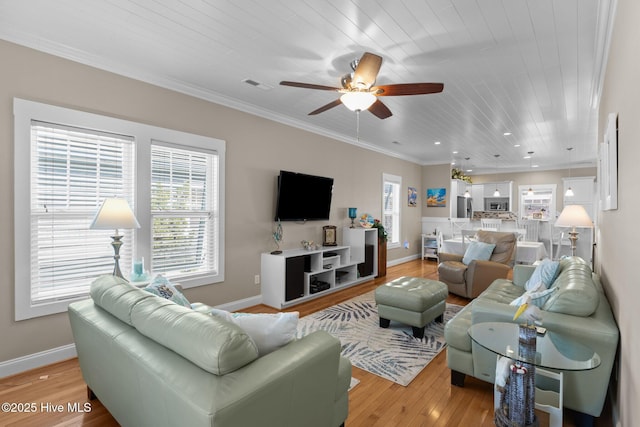 living room featuring visible vents, plenty of natural light, light wood-style floors, and ceiling fan