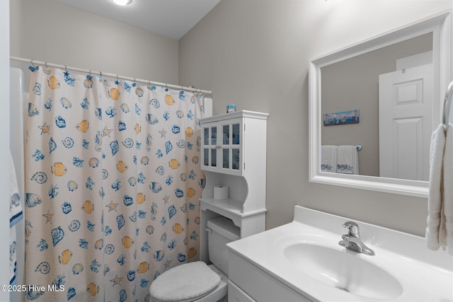 bathroom with vanity, toilet, and a shower with curtain