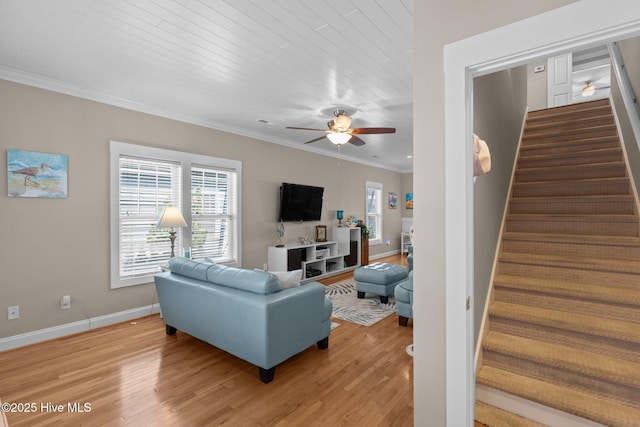 living room featuring stairway, plenty of natural light, ceiling fan, and crown molding