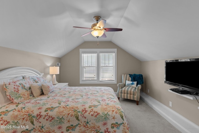 carpeted bedroom with lofted ceiling, baseboards, and ceiling fan