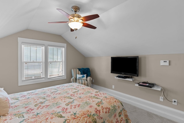 carpeted bedroom featuring baseboards, lofted ceiling, and ceiling fan