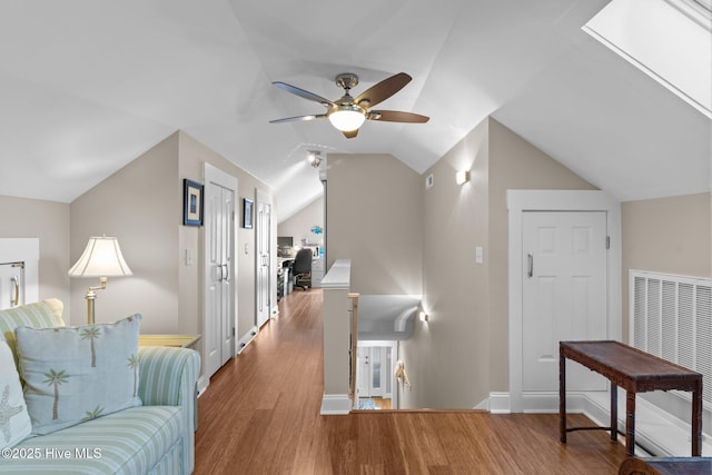 bonus room featuring visible vents, baseboards, ceiling fan, vaulted ceiling, and wood finished floors