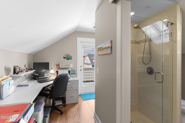 home office featuring light wood-type flooring and lofted ceiling