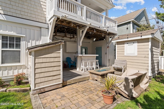 view of patio / terrace featuring an outdoor fire pit and a wooden deck