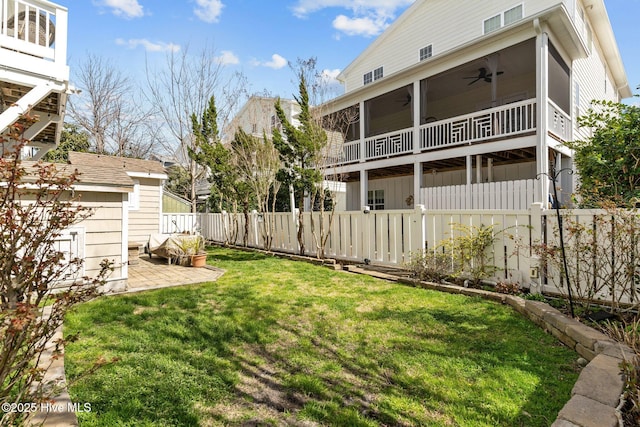 view of yard featuring a patio, fence private yard, a ceiling fan, and a sunroom