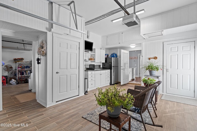 kitchen featuring open shelves, white cabinetry, appliances with stainless steel finishes, a towering ceiling, and wood tiled floor