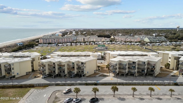 birds eye view of property featuring a beach view and a water view