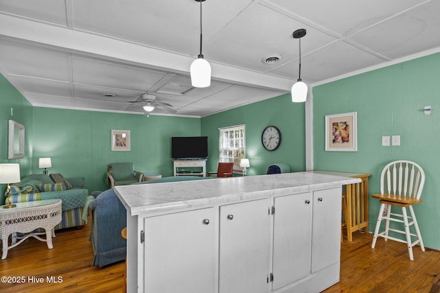 kitchen featuring visible vents, dark wood finished floors, ceiling fan, decorative light fixtures, and white cabinetry