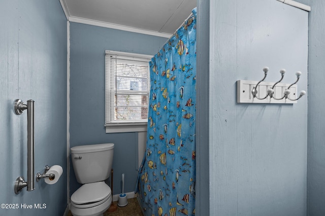 bathroom with ornamental molding, toilet, and a shower with curtain