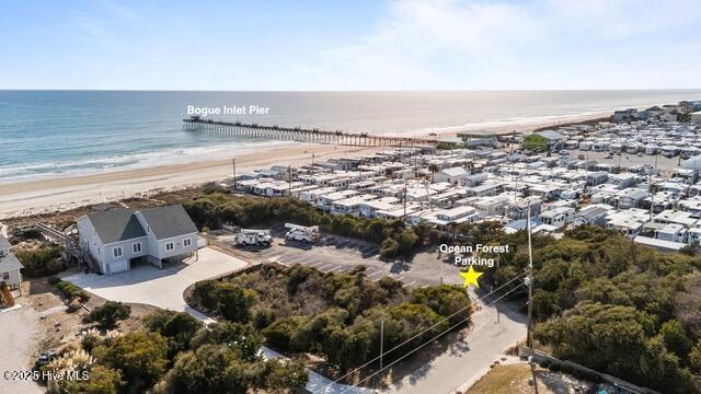 drone / aerial view with a beach view and a water view