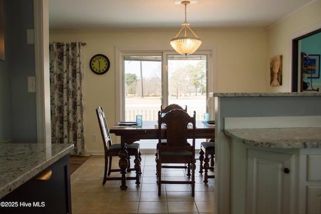 dining area featuring crown molding, light tile patterned flooring, and baseboards