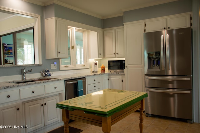 kitchen featuring a sink, ornamental molding, white cabinets, and appliances with stainless steel finishes