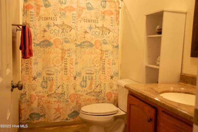 full bathroom featuring toilet, vanity, and a shower with curtain