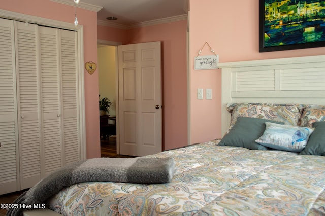 bedroom with a closet and ornamental molding