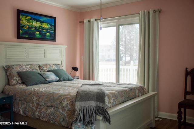 bedroom featuring wood finished floors, baseboards, and ornamental molding