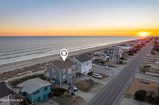 drone / aerial view featuring a water view and a beach view