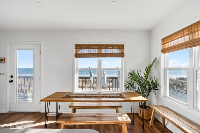 4827 W Beach Dr, Oak Island, NC 28465 - dining area with dark wood-type flooring and a healthy amount of sunlight