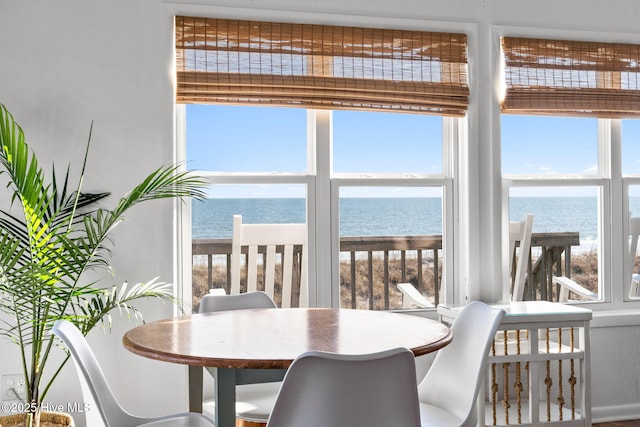 4827 W Beach Dr, Oak Island, NC 28465 - dining area with a water view and a wealth of natural light