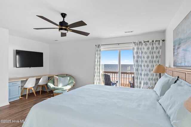 4827 W Beach Dr, Oak Island, NC 28465 - bedroom featuring dark wood-style floors, built in desk, visible vents, a ceiling fan, and access to outside