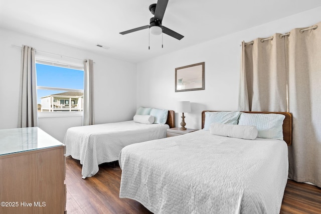 4827 W Beach Dr, Oak Island, NC 28465 - bedroom featuring visible vents, dark wood finished floors, and a ceiling fan