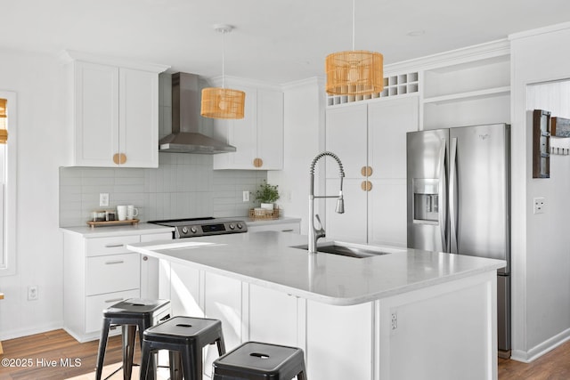 4827 W Beach Dr, Oak Island, NC 28465 - kitchen with white cabinets, a sink, stainless steel appliances, wall chimney range hood, and backsplash