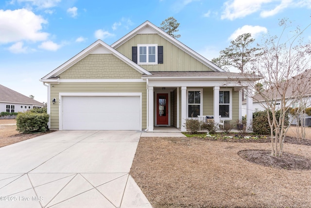 view of front of house featuring board and batten siding, a porch, driveway, and an attached garage