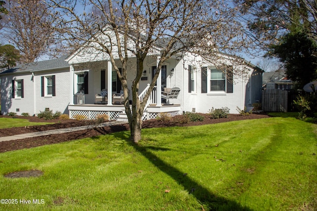 view of front of home featuring fence, covered porch, a front yard, crawl space, and brick siding