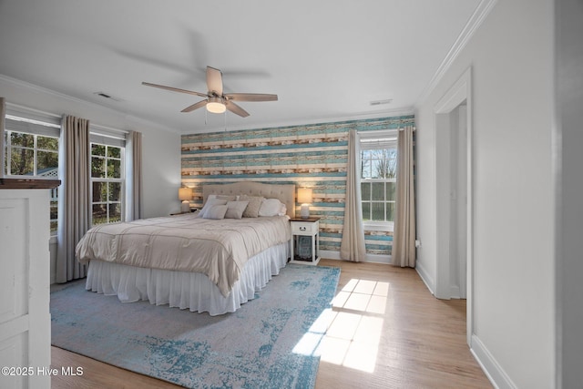 bedroom with wallpapered walls, baseboards, visible vents, ornamental molding, and wood finished floors