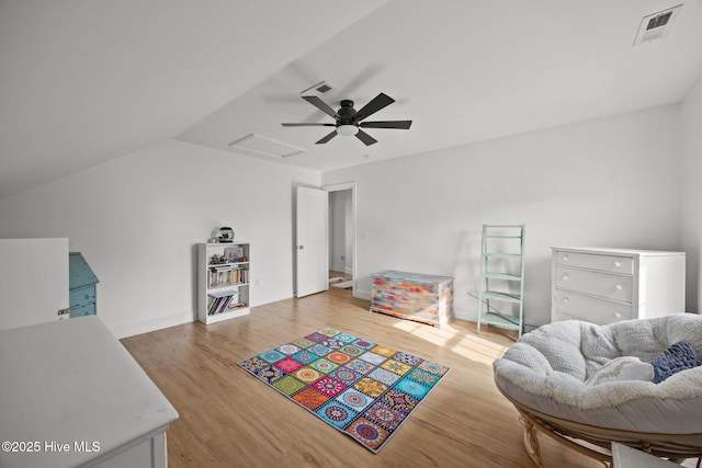 bedroom with attic access, visible vents, and wood finished floors