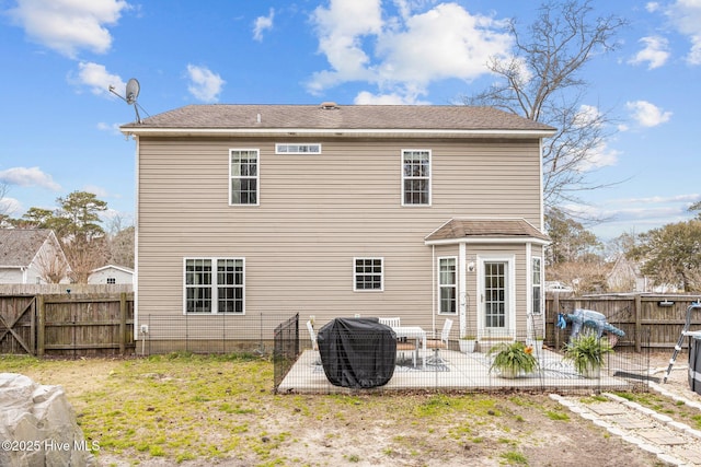 back of property with a patio and a fenced backyard