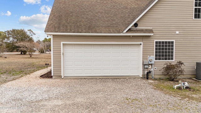 garage with gravel driveway