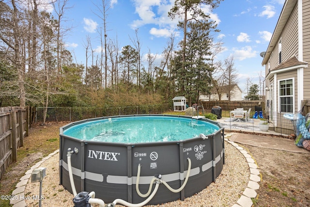 view of pool featuring a patio area, a fenced backyard, and a fenced in pool