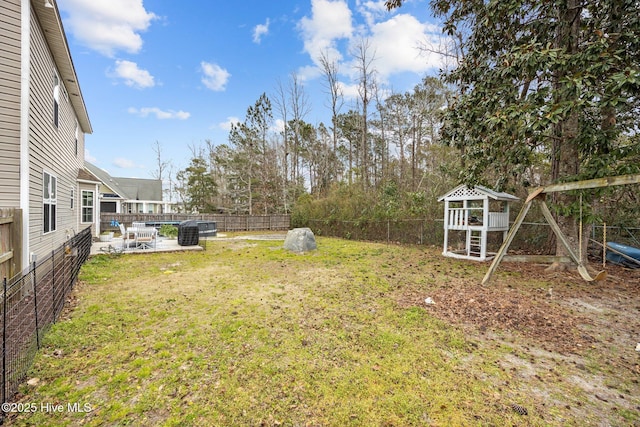 view of yard featuring a playground, a patio area, and a fenced backyard