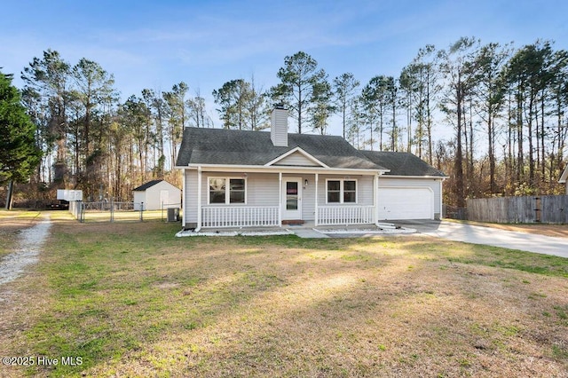 view of front of house with covered porch, fence, a front lawn, and concrete driveway