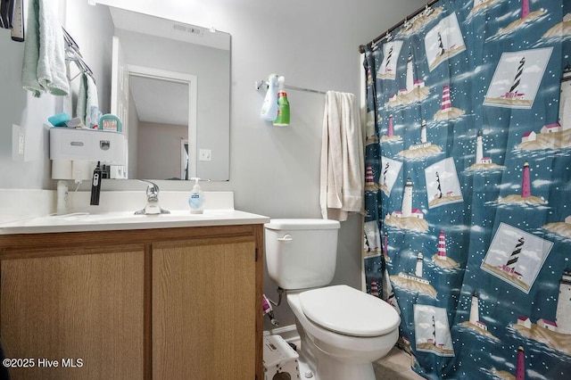 bathroom with toilet, curtained shower, visible vents, and vanity