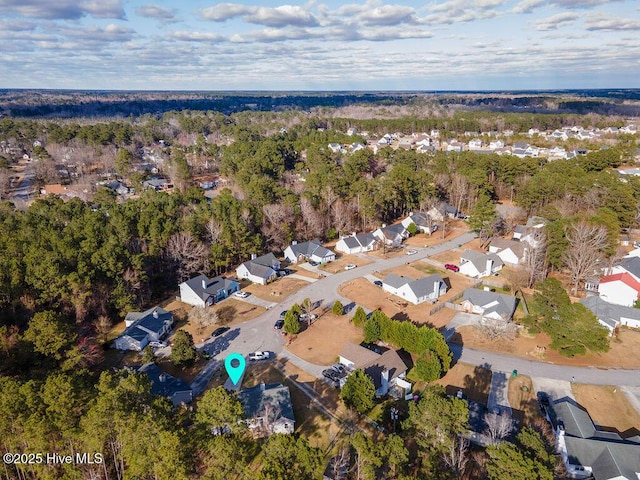 birds eye view of property with a residential view and a view of trees