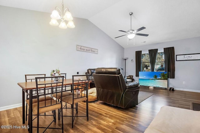 living area with lofted ceiling, ceiling fan with notable chandelier, wood finished floors, and baseboards