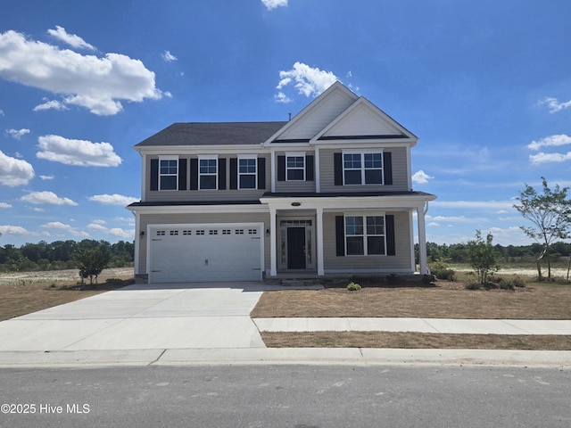 427 Moorland Way, Moyock, NC 27958 - view of front of home with a garage, concrete driveway, and a porch