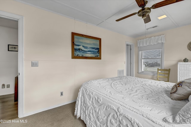 bedroom with carpet, ceiling fan, and visible vents