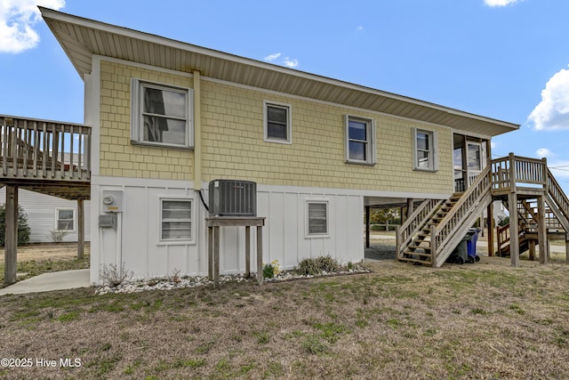 rear view of house featuring stairs, a deck, board and batten siding, and central air condition unit