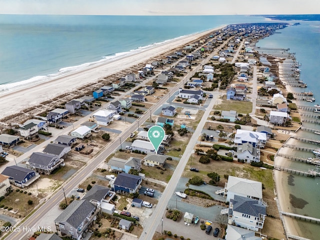 aerial view with a water view and a beach view