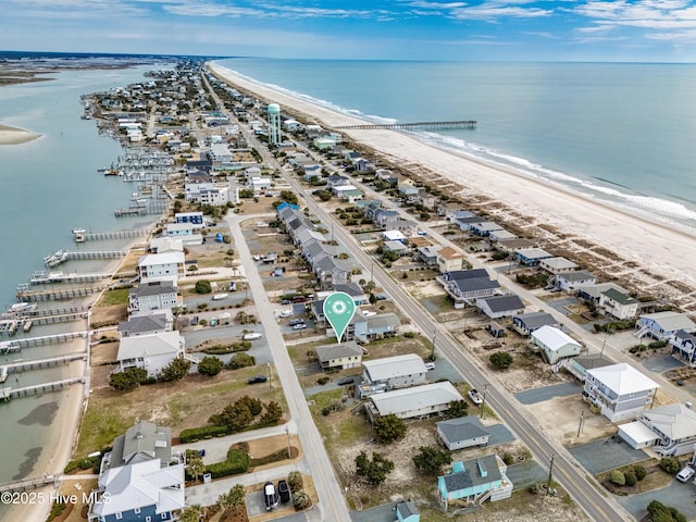 birds eye view of property featuring a beach view and a water view